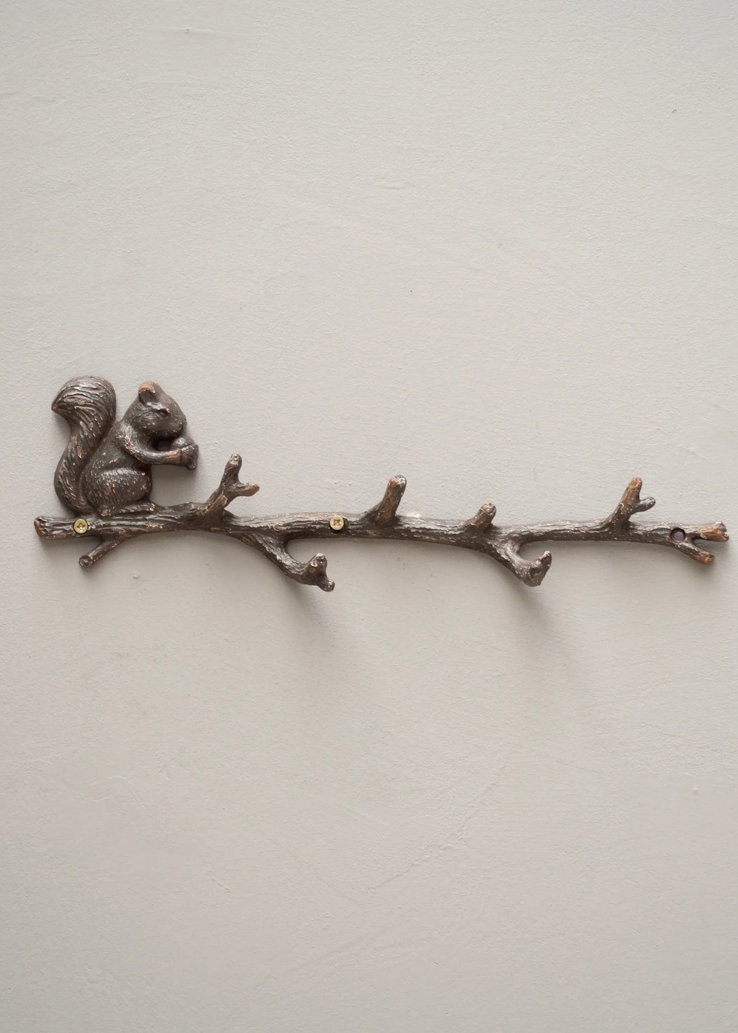 Coat rack with squirrel on branch